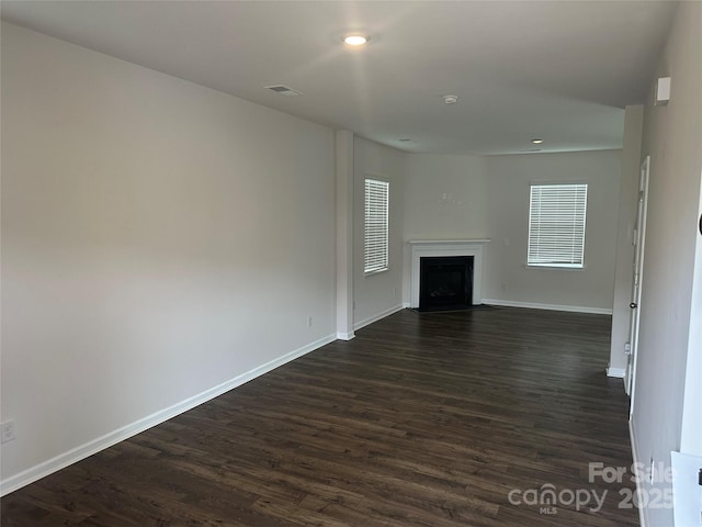 9730 Tea Garden Dr, Gastonia, NC 28056 - unfurnished living room with dark wood-type flooring, baseboards, a fireplace with flush hearth, and recessed lighting
