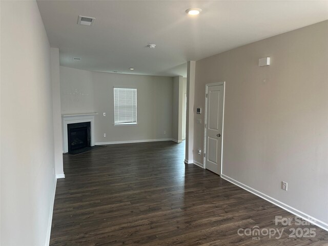 9730 Tea Garden Dr, Gastonia, NC 28056 - unfurnished living room with dark wood-style flooring, baseboards, and a fireplace