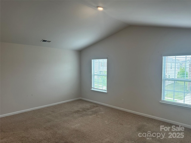 9730 Tea Garden Dr, Gastonia, NC 28056 - empty room featuring vaulted ceiling, plenty of natural light, carpet floors, and baseboards