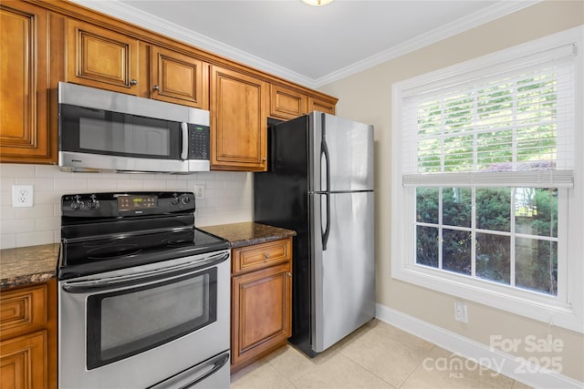 49009 Dockside Ln Unit D, Albemarle, NC 28001 - kitchen with appliances with stainless steel finishes, brown cabinetry, ornamental molding, backsplash, and light tile patterned floors