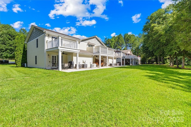 49009 Dockside Ln Unit D, Albemarle, NC 28001 - back of property with ceiling fan, a balcony, a patio area, and a lawn