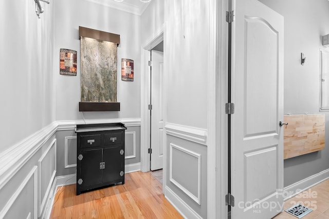 9112 Butterfly Ct, Gastonia, NC 28056 - hallway featuring wainscoting, crown molding, light wood-type flooring, and a decorative wall