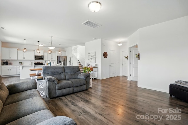 133 Aspire Cir, Wingate, NC 28174 - living area with stairway, dark wood finished floors, and baseboards