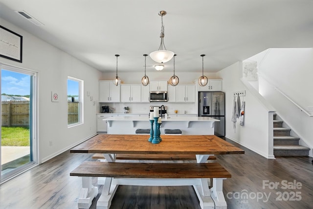 133 Aspire Cir, Wingate, NC 28174 - dining space featuring dark wood-style floors, stairway, and baseboards