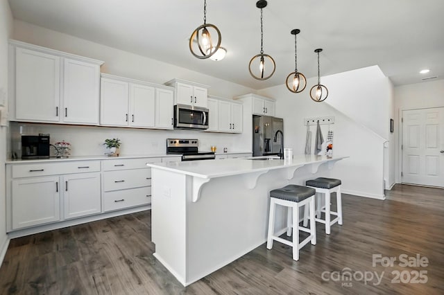 133 Aspire Cir, Wingate, NC 28174 - kitchen with stainless steel appliances, dark wood-style flooring, a sink, a center island with sink, and recessed lighting