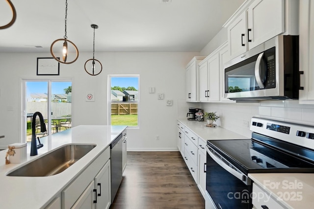 133 Aspire Cir, Wingate, NC 28174 - kitchen with appliances with stainless steel finishes, a sink, dark wood-style flooring, light countertops, and backsplash