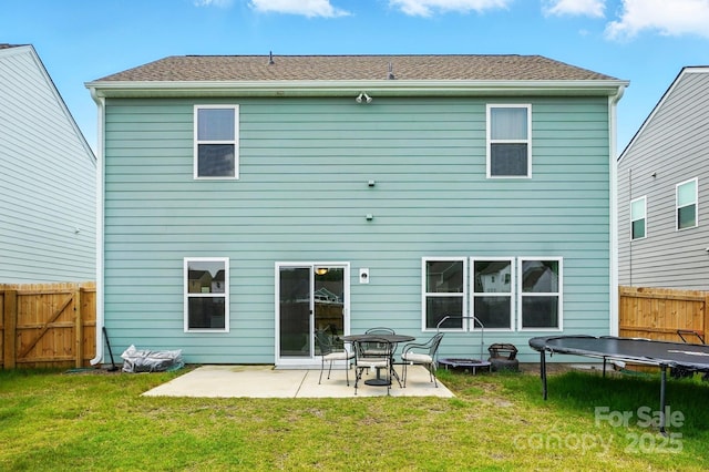 133 Aspire Cir, Wingate, NC 28174 - back of property featuring a trampoline, a patio area, and a gate