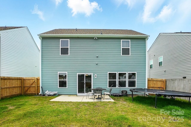 133 Aspire Cir, Wingate, NC 28174 - rear view of property featuring a trampoline, a patio area, and a fenced backyard