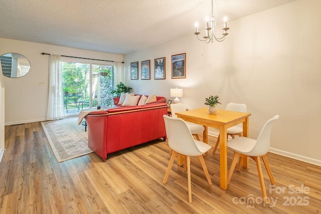 118 Colony Dr, Arden, NC 28704 - living room featuring a chandelier, light wood-style floors, and a textured ceiling