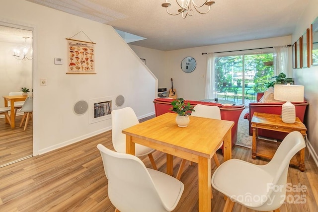 118 Colony Dr, Arden, NC 28704 - dining room featuring a chandelier, light wood-style floors, heating unit, and stairs