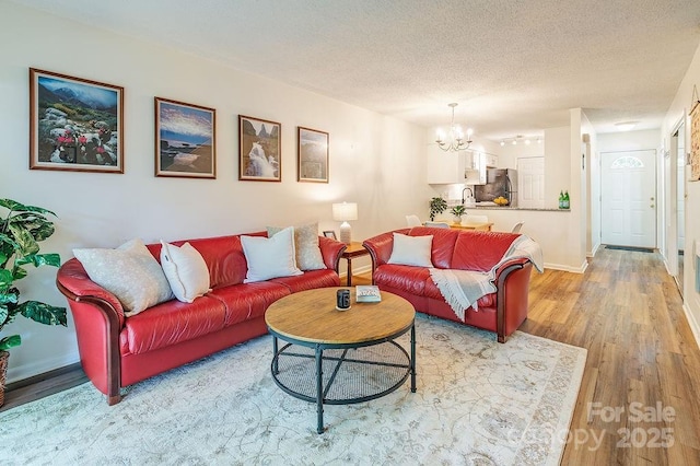 118 Colony Dr, Arden, NC 28704 - living area with a chandelier, light wood-style floors, and a textured ceiling