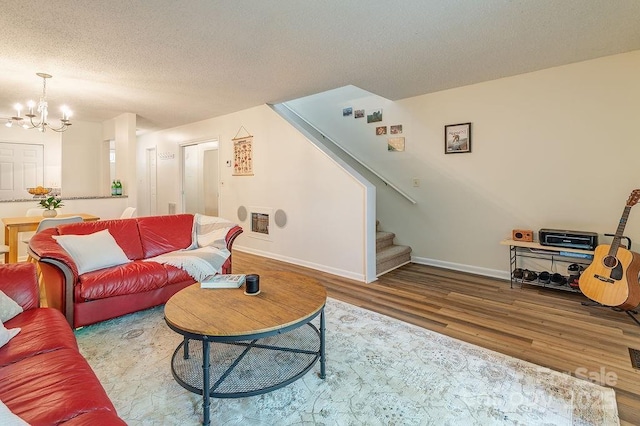 118 Colony Dr, Arden, NC 28704 - living area featuring wood finished floors, stairs, a chandelier, and a textured ceiling