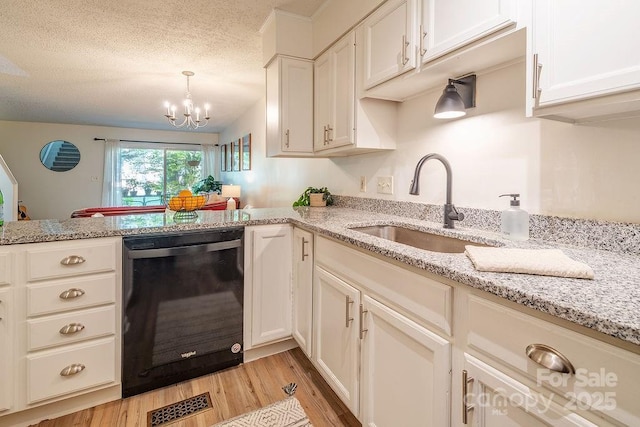 118 Colony Dr, Arden, NC 28704 - kitchen featuring dishwasher, light wood finished floors, a chandelier, a peninsula, and light stone countertops