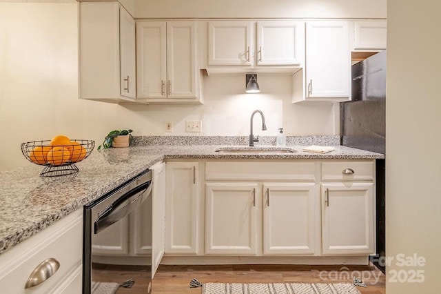 118 Colony Dr, Arden, NC 28704 - kitchen featuring dishwashing machine, light stone counters, white cabinetry, and wood finished floors