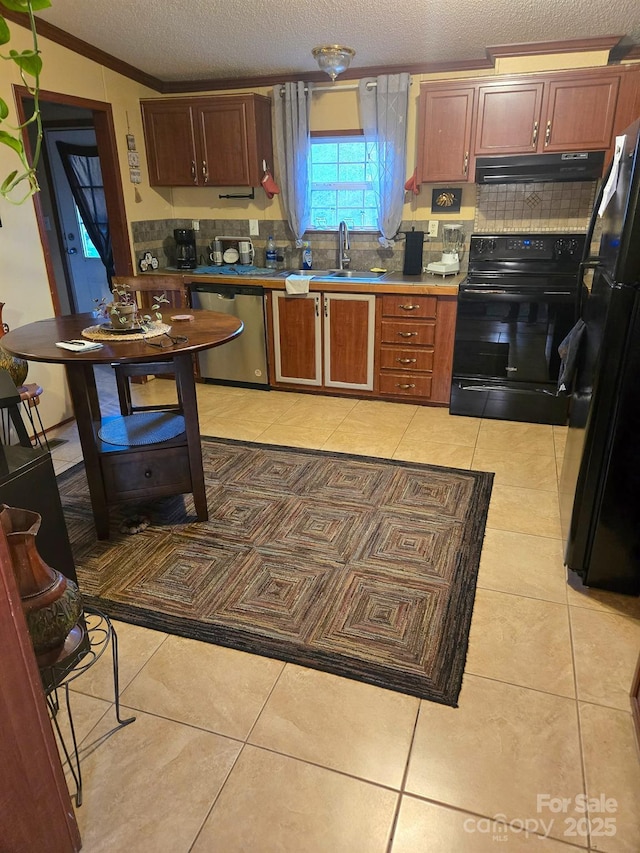 110 Dorothy Ln, Mooresville, NC 28117 - kitchen with black appliances, under cabinet range hood, backsplash, a sink, and light tile patterned floors
