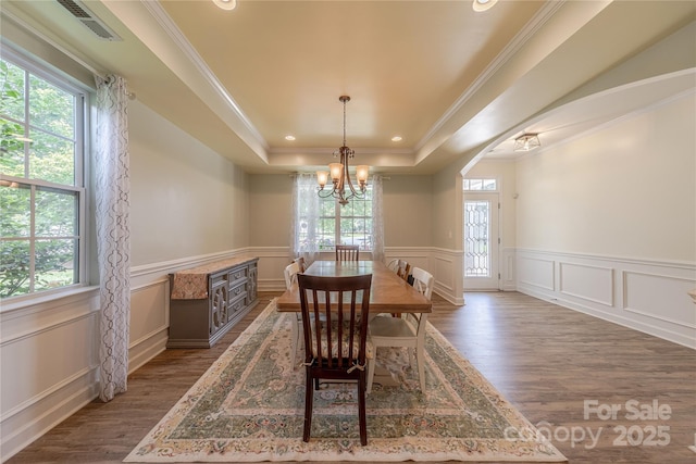 516 Fair Oaks Dr, Fort Mill, SC 29708 - dining space featuring plenty of natural light, wood finished floors, a chandelier, ornamental molding, and a wainscoted wall