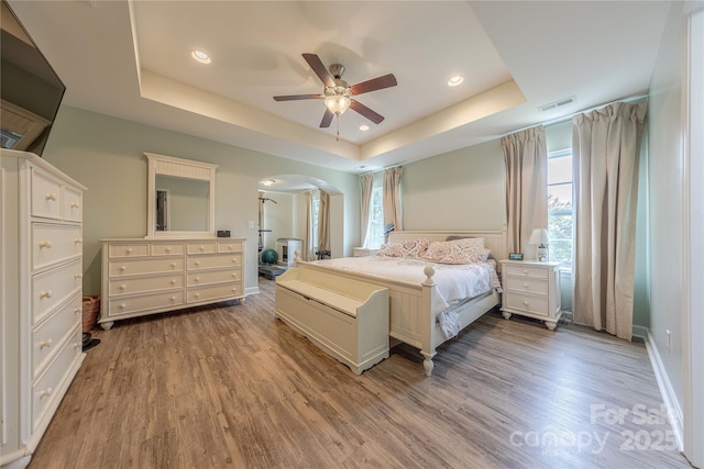 516 Fair Oaks Dr, Fort Mill, SC 29708 - bedroom with a raised ceiling, arched walkways, wood finished floors, recessed lighting, and ceiling fan