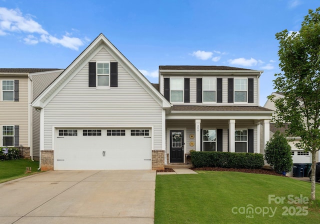 204 Fesperman Cir, Troutman, NC 28166 - view of front facade with driveway, a front yard, a garage, brick siding, and covered porch