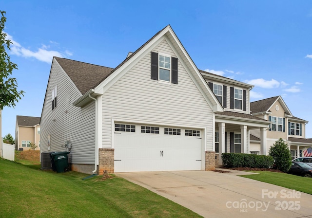 204 Fesperman Cir, Troutman, NC 28166 - view of front of home featuring a front yard, concrete driveway, brick siding, and an attached garage