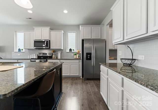 204 Fesperman Cir, Troutman, NC 28166 - kitchen with stainless steel appliances, tasteful backsplash, white cabinetry, and recessed lighting