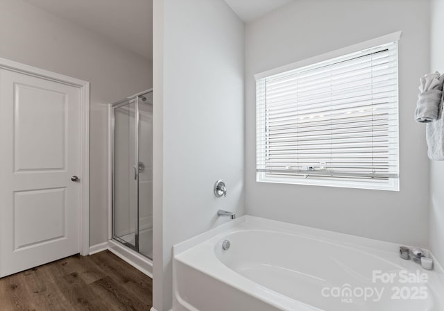 204 Fesperman Cir, Troutman, NC 28166 - full bath featuring a garden tub, a shower stall, and wood finished floors