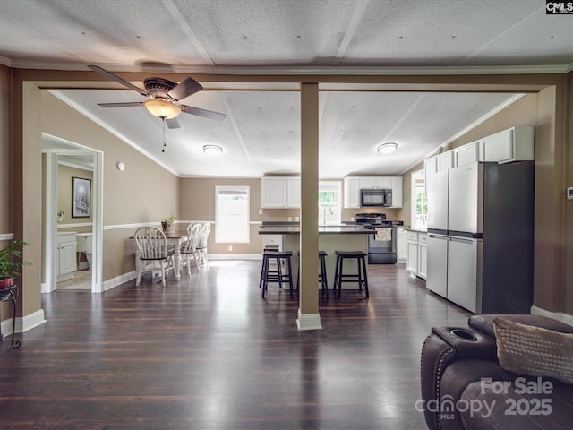 1989 White Oak Rd, Camden, SC 29020 - living room featuring crown molding, ceiling fan, dark wood-type flooring, and baseboards