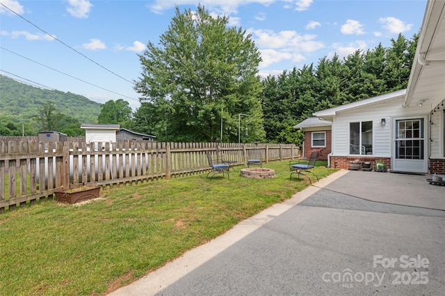 58 Campbell Creek Rd, Maggie Valley, NC 28751 - fenced backyard featuring a fire pit and a patio