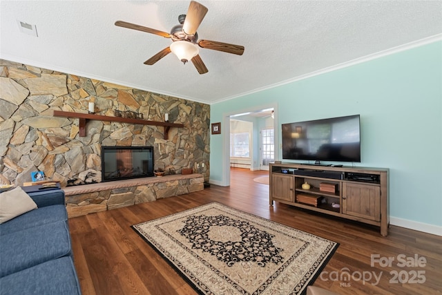 58 Campbell Creek Rd, Maggie Valley, NC 28751 - living room with ceiling fan, crown molding, dark wood-style floors, a textured ceiling, and a fireplace