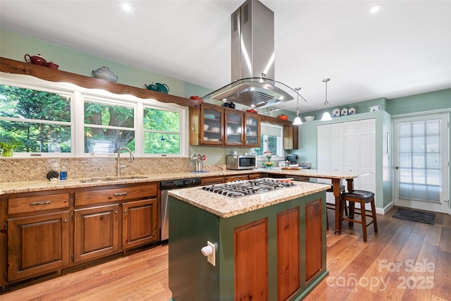 58 Campbell Creek Rd, Maggie Valley, NC 28751 - kitchen with island range hood, stainless steel appliances, light wood-type flooring, and light stone countertops