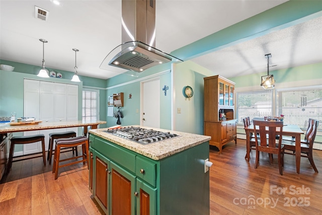 58 Campbell Creek Rd, Maggie Valley, NC 28751 - kitchen with island range hood, green cabinetry, stainless steel gas stovetop, a center island, and light wood-style floors