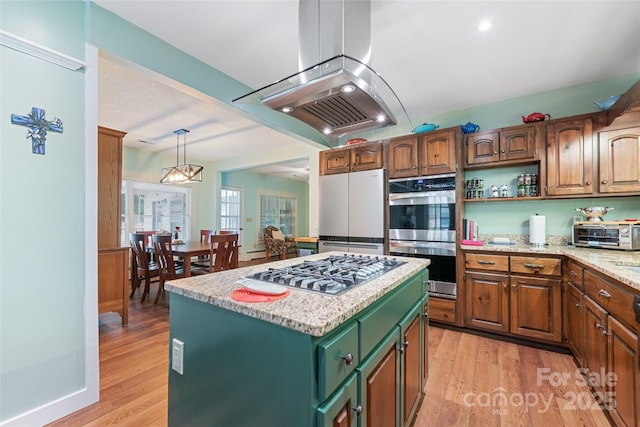 58 Campbell Creek Rd, Maggie Valley, NC 28751 - kitchen with appliances with stainless steel finishes, island range hood, light wood-style floors, and a kitchen island