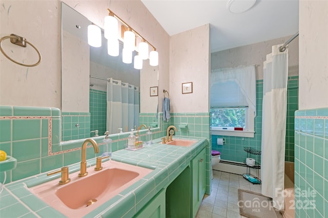 58 Campbell Creek Rd, Maggie Valley, NC 28751 - full bathroom with tile walls, a baseboard radiator, double vanity, curtained shower, and tile patterned floors