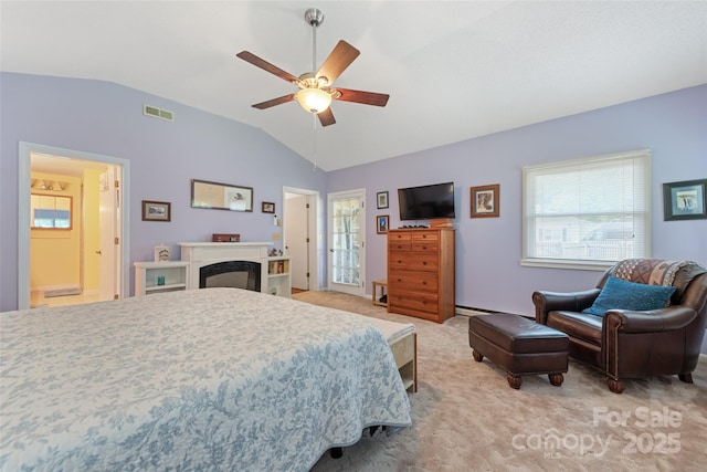 58 Campbell Creek Rd, Maggie Valley, NC 28751 - bedroom with vaulted ceiling, light carpet, multiple windows, a fireplace, and ceiling fan