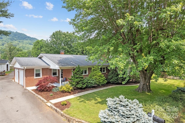 58 Campbell Creek Rd, Maggie Valley, NC 28751 - single story home with brick siding, a garage, a front yard, a chimney, and a mountain view