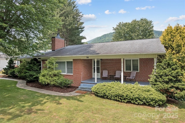 58 Campbell Creek Rd, Maggie Valley, NC 28751 - ranch-style home with brick siding, a front yard, a chimney, and roof with shingles