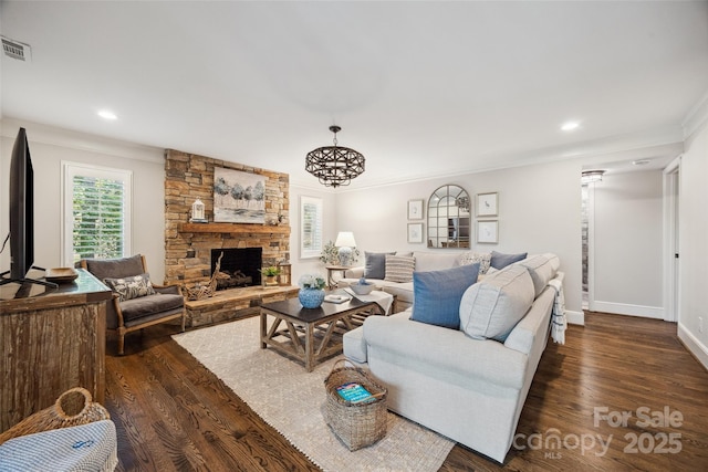 2004 Marquesas Ave, Tega Cay, SC 29708 - living area featuring dark wood finished floors, recessed lighting, a stone fireplace, and crown molding