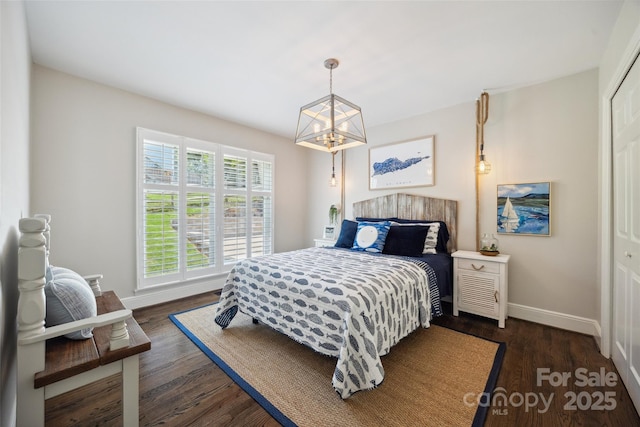2004 Marquesas Ave, Tega Cay, SC 29708 - bedroom featuring dark wood-style flooring and a chandelier