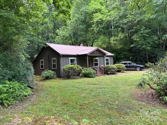 2070 Cashiers Valley Rd, Brevard, NC 28712 - view of front of property featuring board and batten siding, a front lawn, and a view of trees