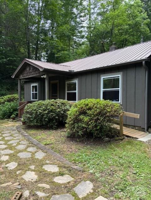 2070 Cashiers Valley Rd, Brevard, NC 28712 - view of side of property featuring board and batten siding, a metal roof, and a chimney