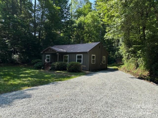 2070 Cashiers Valley Rd, Brevard, NC 28712 - view of front of property with gravel driveway, board and batten siding, a front lawn, and a metal roof