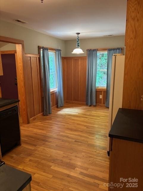 2070 Cashiers Valley Rd, Brevard, NC 28712 - dining space featuring light wood-style flooring, wooden walls, and wainscoting