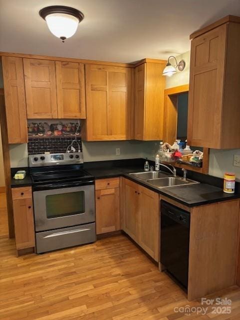 2070 Cashiers Valley Rd, Brevard, NC 28712 - kitchen with stainless steel electric range, black dishwasher, dark countertops, and light wood finished floors
