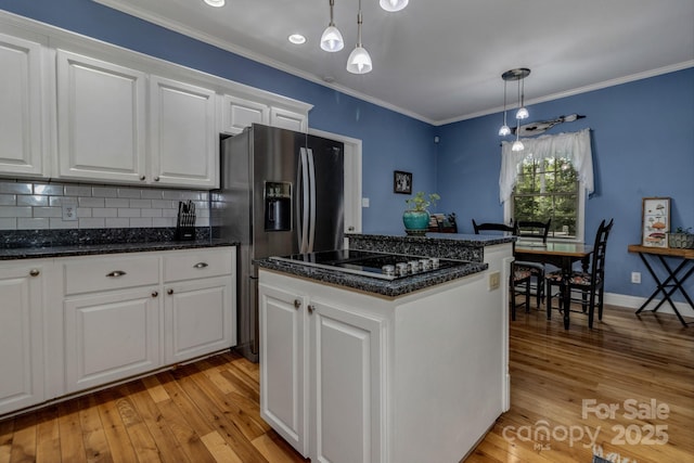 2790 Twin Oaks Dr, Morganton, NC 28655 - kitchen featuring black electric stovetop, light wood-style flooring, white cabinetry, pendant lighting, and crown molding