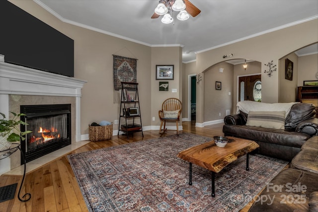 2790 Twin Oaks Dr, Morganton, NC 28655 - living area featuring a ceiling fan, hardwood / wood-style floors, ornamental molding, arched walkways, and a high end fireplace