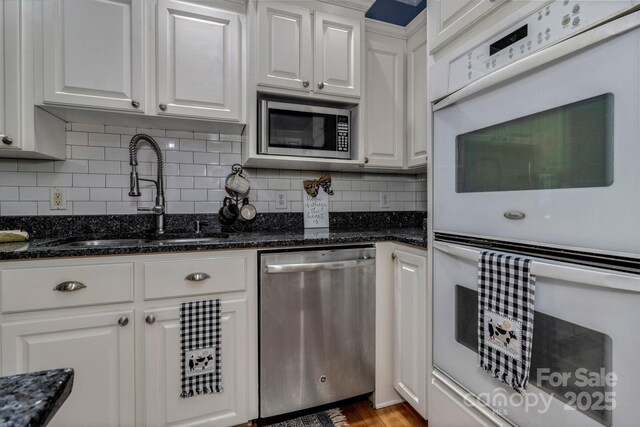2790 Twin Oaks Dr, Morganton, NC 28655 - kitchen featuring appliances with stainless steel finishes, white cabinets, and backsplash
