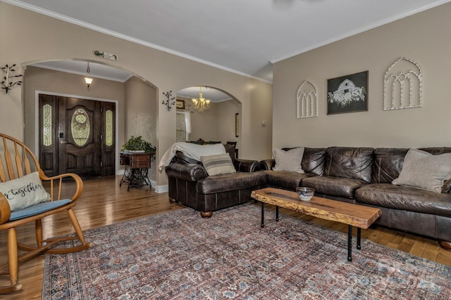 2790 Twin Oaks Dr, Morganton, NC 28655 - living room featuring arched walkways, wood finished floors, ornamental molding, and a chandelier