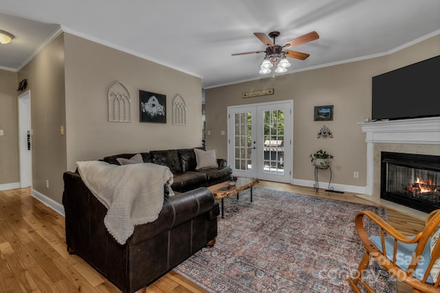2790 Twin Oaks Dr, Morganton, NC 28655 - living room with light wood-type flooring, ceiling fan, a fireplace with flush hearth, crown molding, and french doors