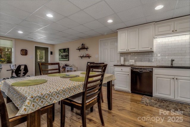 2790 Twin Oaks Dr, Morganton, NC 28655 - kitchen featuring dishwasher, light wood-style flooring, dark countertops, white cabinetry, and a paneled ceiling