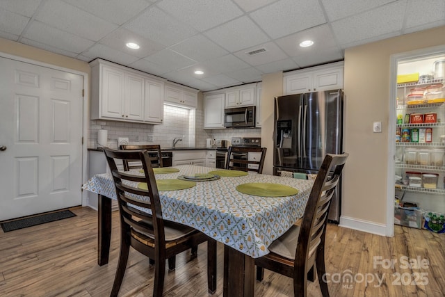 2790 Twin Oaks Dr, Morganton, NC 28655 - dining area featuring light wood-type flooring, a drop ceiling, and recessed lighting