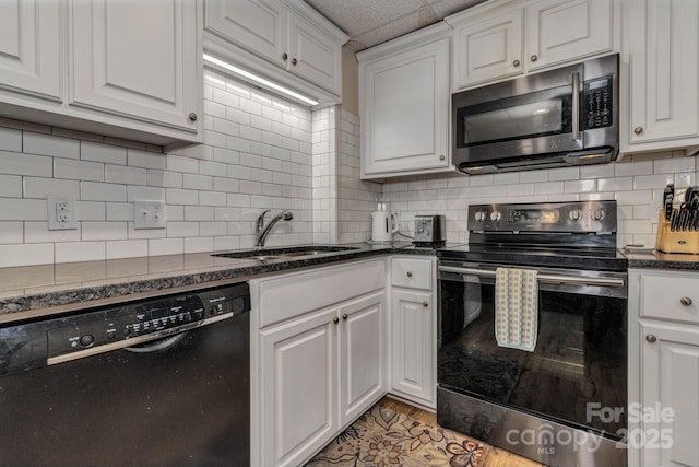 2790 Twin Oaks Dr, Morganton, NC 28655 - kitchen featuring stainless steel appliances, white cabinetry, tasteful backsplash, and dark stone countertops